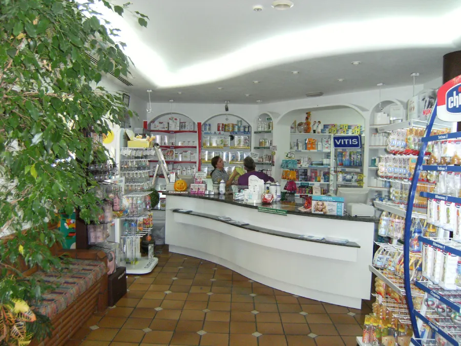Zona de atención al cliente en la farmacia La Botica antes de la reforma, con mostradores mal ubicados, iluminación deficiente y poco atractivo